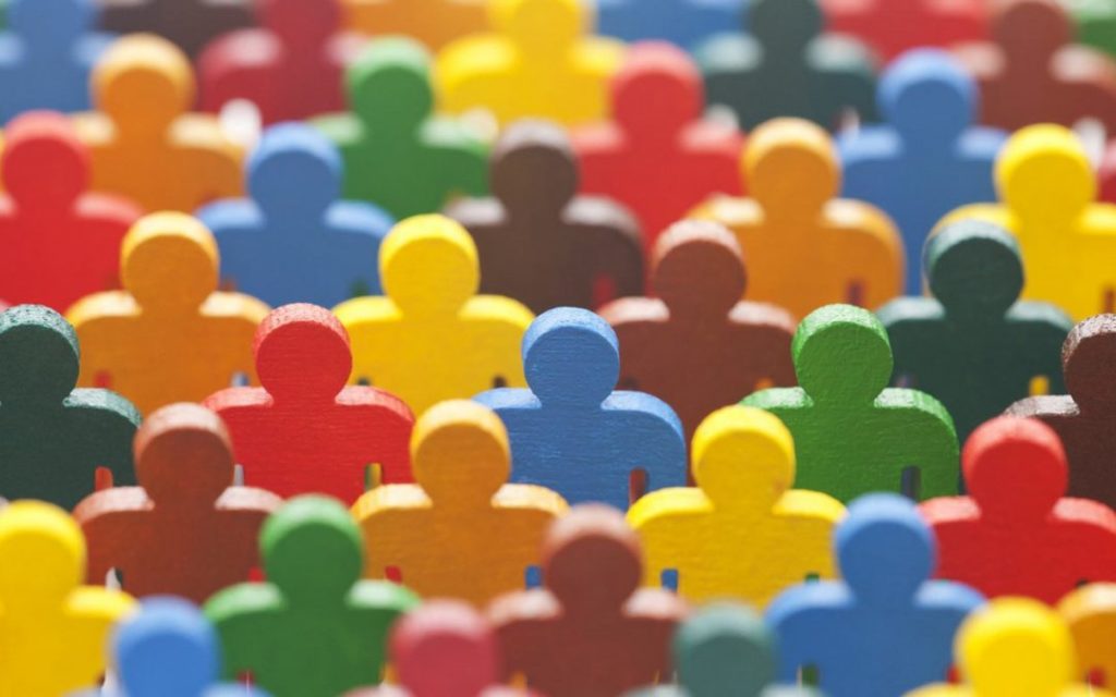 Photo of wooden human figures in all different colours