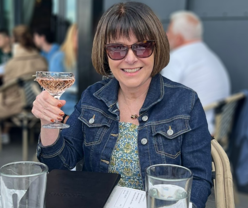 Karen Miller is pictured at a restaurants with a drink in her hand. 