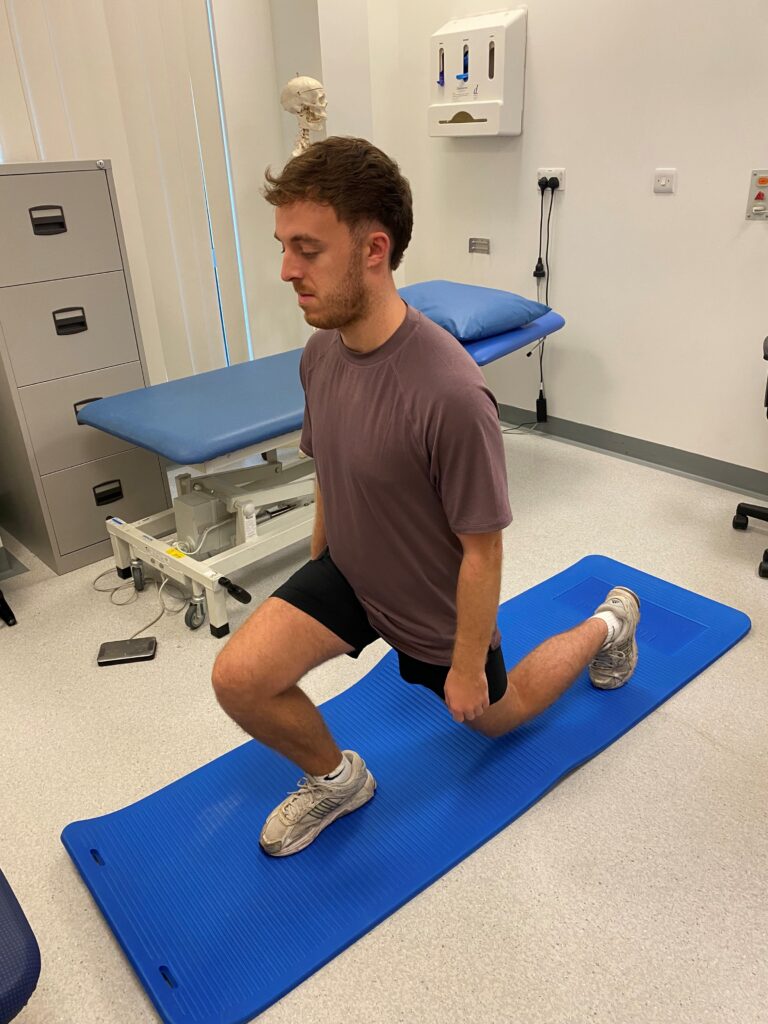 Picture of someone lunging on a mat. 