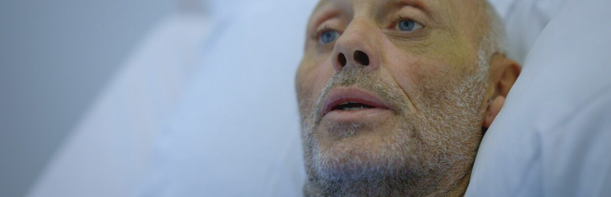 A man lying in a hospital bed