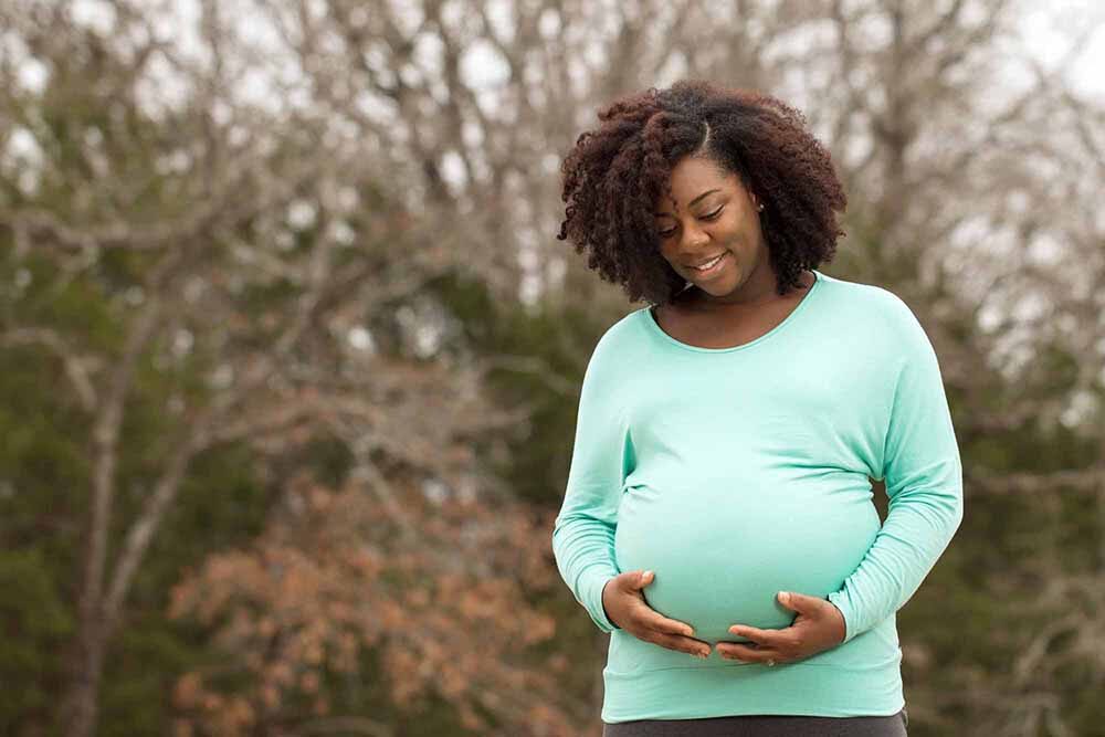 A pregnant woman holding her belly