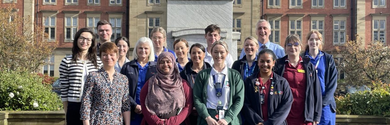 A photo of the paediatric brain tumour team standing outside Peacock Hall at the RVI