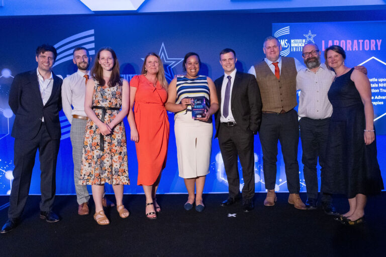A group of people standing together after receiving an award