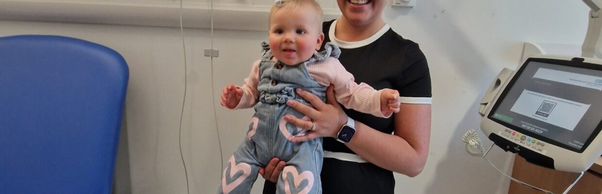Mum Leona is pictured holding her baby, Hollie-Mae, in a hospital room.