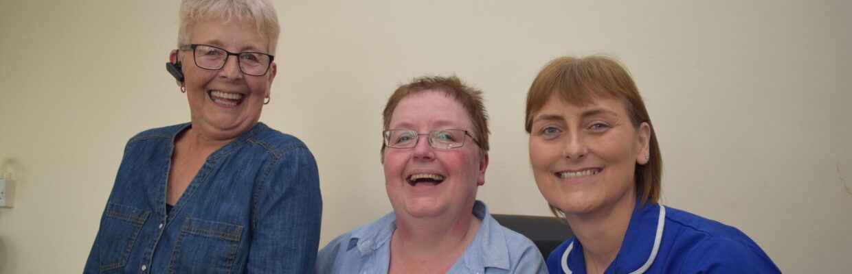 A photo of two women with a nurse