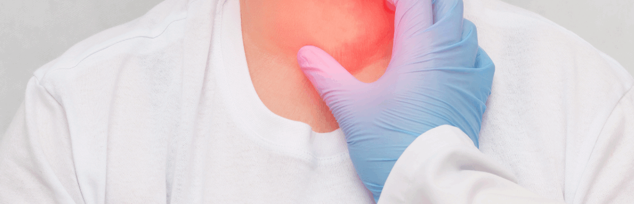 A photo of a doctor touching a mans neck which is red and inflamed