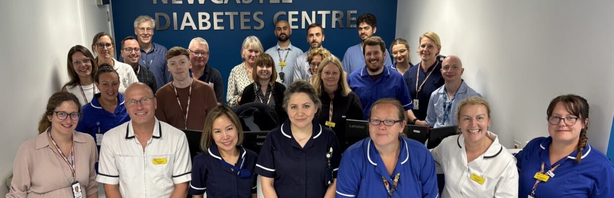 A group of staff standing in front of a Newcastle Diabetes Centre sign